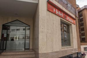 a building with a sign on the side of it at Hotel Plaza in Cuenca