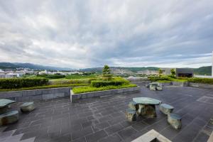 a patio with benches and a view of a city at Formosan Naruwan Garden Hotel in Taitung City