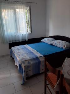 Postel nebo postele na pokoji v ubytování Apartmani Lana Rab