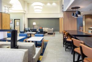 a dining room with tables and chairs and a chalkboard at Hyatt House Chicago Schaumburg in Schaumburg +77 photos