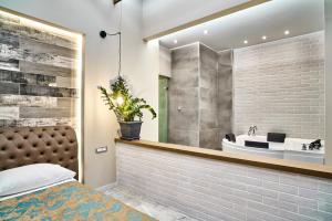 a bathroom with a bed and a sink at Minoos Hotel in Chania Town +25 photos