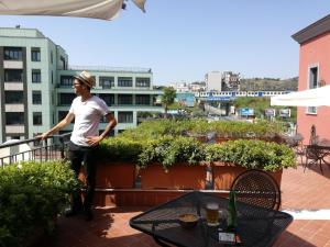 a man standing on top of a balcony at Hotel Nuvò in Naples