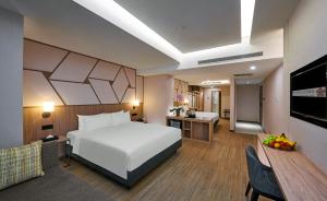 Postel nebo postele na pokoji v ubytování Swiss-Garden Hotel Bukit Bintang Kuala Lumpur