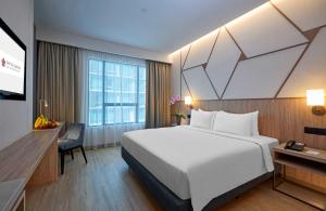 Postel nebo postele na pokoji v ubytování Swiss-Garden Hotel Bukit Bintang Kuala Lumpur