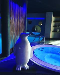 a white vase sitting on a table next to a tub at Best Western Plus La Fayette Hotel et SPA in Épinal