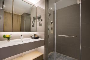 a bathroom with a sink and a shower at Citadines Keqiao Shaoxing in Shaoxing