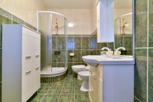 a bathroom with a sink and a toilet and a tub at Apartment Ruzica in Sveti Stefan +15 photos