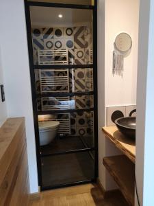 a glass cabinet filled with plates and bowls at Ardenne BnB gîte urbain avec terrasse in Marche-en-Famenne