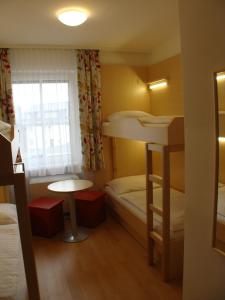 A bed or beds in a room at Jugendgästehaus St. Gilgen