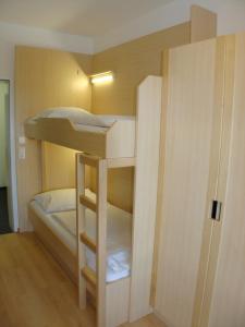 A bed or beds in a room at Jugendgästehaus St. Gilgen