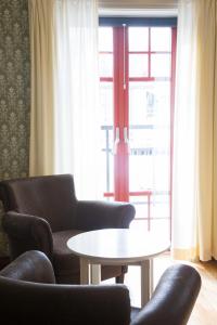 a living room with two chairs and a table and a window at Hovde Hotell in Vemdalsskalet +26 photos
