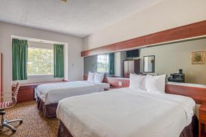 Ένα ή περισσότερα κρεβάτια σε δωμάτιο στο Trident Inn & Suites, Baton Rouge +36 φωτογραφίες