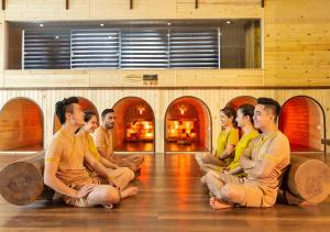 a group of men sitting on the floor in a room at Duc Huy Grand Hotel in Lao Cai