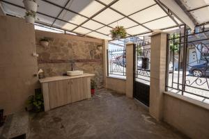 a bathroom with a sink in a room with windows at Tiffany Boutique Suits - Pomorie in Pomorie +17 photos