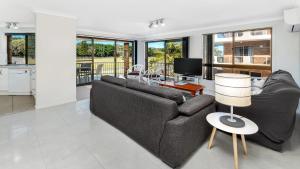 a living room with a couch and a table at Beach Point - East Ballina in East Ballina