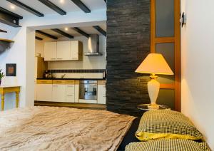 a bedroom with a bed and a table with a lamp at Ferienwohnung Tannenweg in Baden-Baden