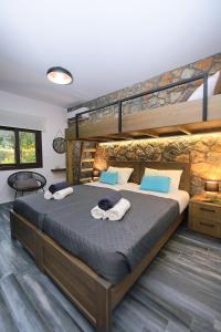 a bedroom with two bunk beds with towels on them at Aithonas Villa in Archangelos