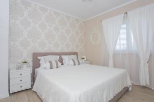 Posteľ alebo postele v izbe v ubytovaní Apartman Slavice