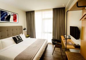 a hotel room with a bed and a desk at H Boutique Hotel, Kota Damansara in Kota Damansara
