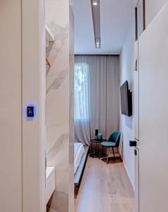 a room with a bed and a table and a tv at Le Palmette Suites in Cagliari