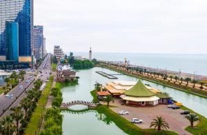 a view of a city with a river and a bridge at Apartment Miracle in Batumi