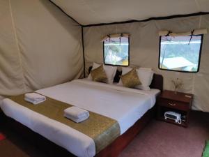 a bedroom with a bed in a tent at Ourguest Camp Lachung in Lachung