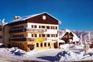 a large building with snow on the roof of it at Gaberlhaus in Salla