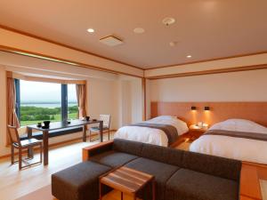a bedroom with two beds and a desk and a couch at Hokuten no Oka Abashiriko Tsuruga Resort in Abashiri +105 photos