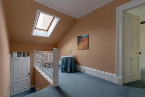 a home hallway with a skylight and a window at The Midsands Apartment in Ayr
