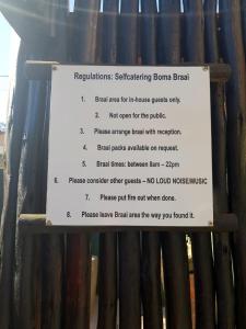 a sign in front of a bamboo fence at Imperani Guesthouse in Ficksburg