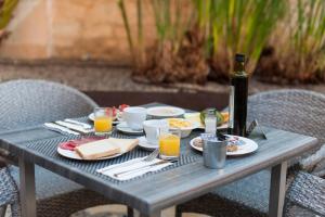 a picnic table with food and a bottle of wine at Alcudia Petit - Turismo de Interior in Alcudia