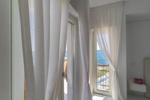 a room with a window with a view of the ocean at Santa Rosa luxury apartment 2 BEDROOMS 4 People private parking in Trani