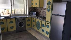 a kitchen with a refrigerator and a washing machine at Arabesque Style - 2 appartements in Kelibia