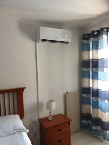 a bedroom with a bed and a air conditioner on the ceiling at Guesthouse Korzo in Rijeka