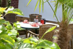 an outdoor table with cups and a figurine on it at Ferienhaus ODIN in Großräschen