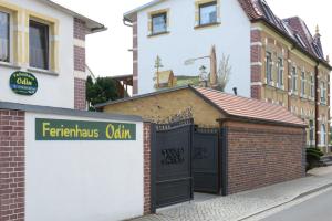 a building with a black gate in a street at Ferienhaus ODIN in Großräschen