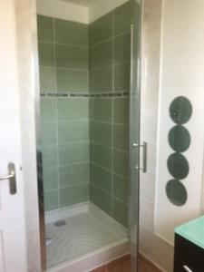 a shower with a glass door in a bathroom at Chambre en Ardèche du Sud in Saint-Remèze