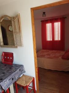 a bedroom with a bed and a mirror and a table at L Appicciu in Ventiseri