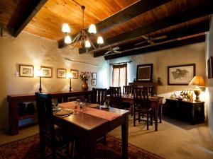 a dining room with a table and some chairs at Leeuwenbosch Country House - Amakhala Game Reserve in Amakhala Game Reserve
