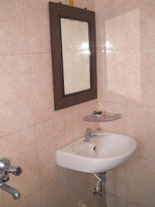 a bathroom with a sink and a mirror at Hotel Galaxy in Patna