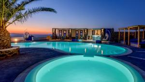 a swimming pool with a view of a resort at Anemomilos in Oia