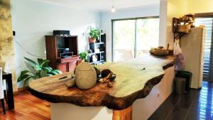 a large wooden table in a living room at Rochas Shared Apart Garden Refuge in Funchal