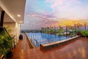 a large swimming pool with lights on a building at Aviary Bintaro in Serpong