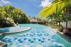 una piscina con suelo de baldosa azul y blanco en Sheridan Boutique Resort Iloilo en Iloilo