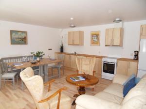 a kitchen and living room with a table and a couch at Mellby Ör Inn in Mellby