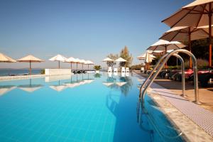 a swimming pool with umbrellas and a slide at Sunnyside Apartments Resort Petrcane in Petrcane