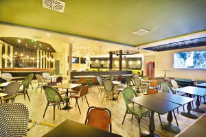 a restaurant with tables and chairs and a bar at Barceló Teguise Beach - Adults Only in Costa Teguise