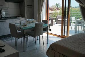 a bedroom with a table and chairs and a kitchen at Boccy Brothers in Formia