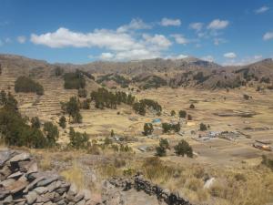 a view of a field with mountains in the background at Hostal Campestre Casa Blanca in Chucuito