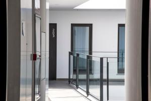 a balcony with glass railing in a building at gm hotel in Marchena